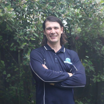 Troy Harvey smiling confidently, representing reliable Pest Control for Businesses services.